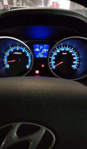 A new car in a showroom with its front dashboard display prominently featured
