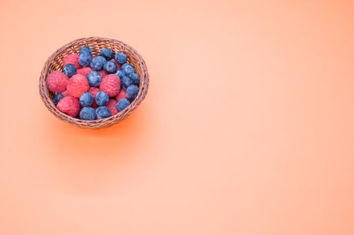 A closeup shot of blueberries raspberries in a basket