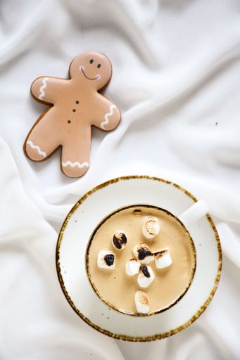 A white plate with a bowl and several human-shaped cookies