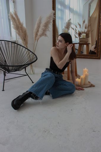 A vertical shot of a Caucasian female posing for a photo indoors