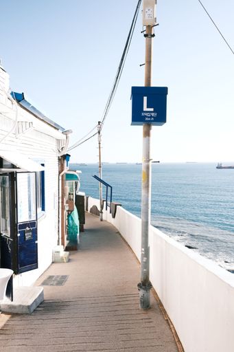 A scenic view of a boardwalk with the deep blue ocean in the background