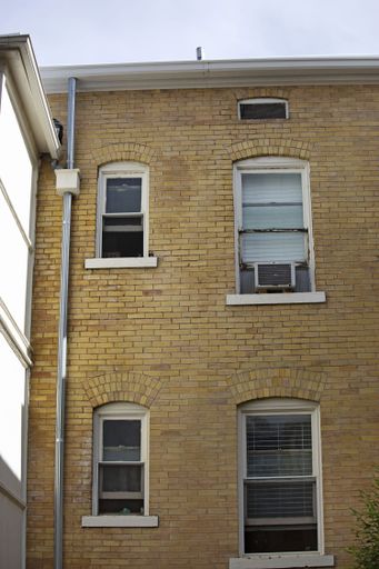 A shot of an old-fashioned building with yellow bricks captured from the front.