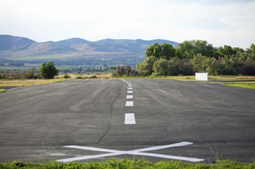 A shot of a road for a car starting from the point marked with a sign in a natural environment.