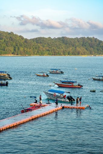 colorful boats near the floating jetty on Perhentian Island in the morning.