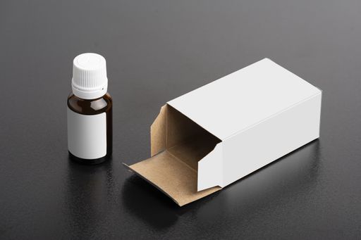 A children's dietary supplement glass bottle with a package in the dark background, editable mock-up series ready for design, selection path included