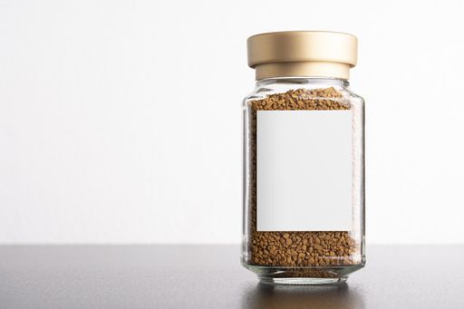 Instant coffee in a glass jar with blank label in white background, editable mock-up series template ready for design, label selection path included