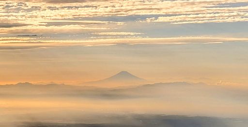 A breathtaking scenery of Mount Fuji from the sky, golden sunset