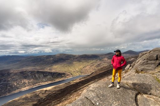 A woman standing on top of the Slieve Binnian Mountains, North Ireland