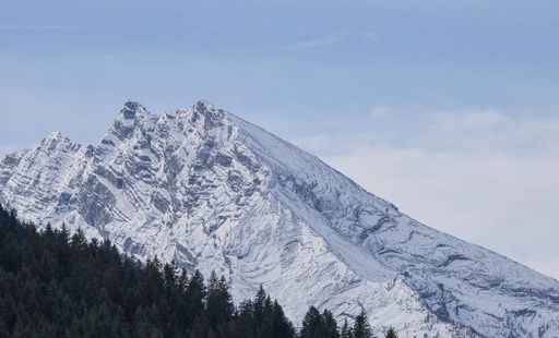 A scenic view of a snowy mountain range of Watzmann, Germany