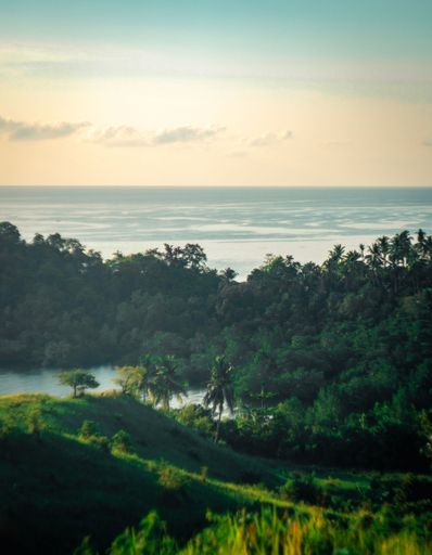 A tranquil landscape featuring a large body of water surrounded by lush green trees, rolling hills, and snow-capped mountain peaks in the background