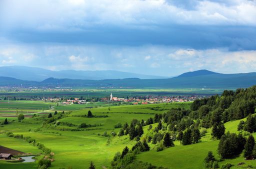A beautiful rural landscape with a farm field in Transylvania under a cloudy sky