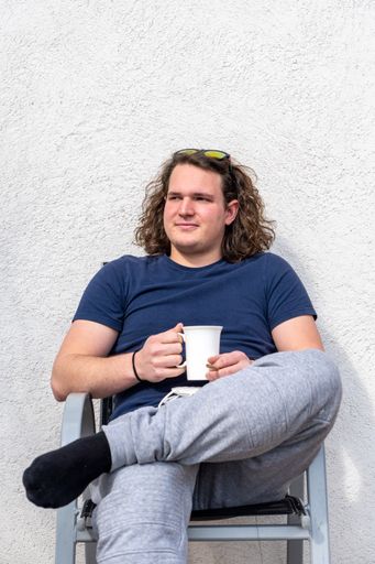 a vertical shot of a middle eastern male with curly long hair on white background