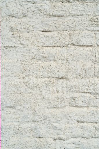 A rough surface of a white plaster texture, the wall of an old house