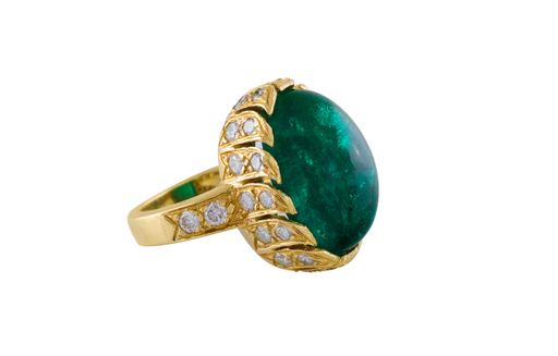 An expensive ring with big emerald and diamonds isolated on a white background