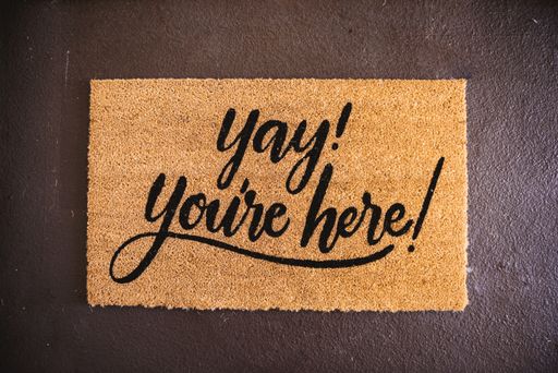 A high angle shot of a foot rug with a text "Yay! you're here!"