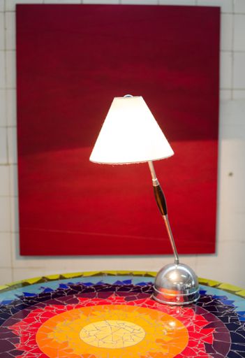 A closeup shot of a modern desk lamp in the cozy room