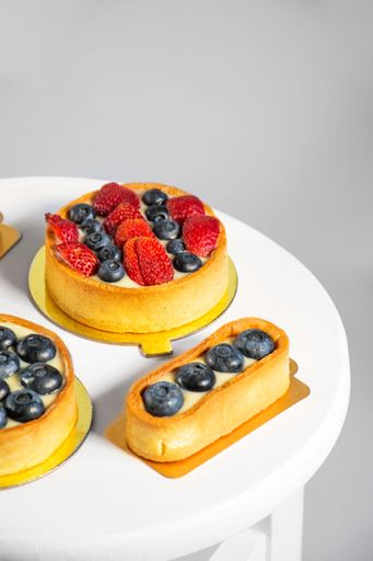 A closeup shot of delicious tarts with strawberries and blueberries