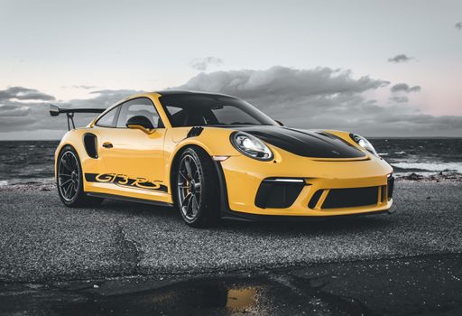 A nice Porsche GT3 RS down by the beach in selective color showing just the yellow or the paint