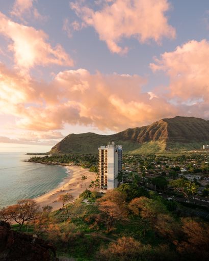 A vertical shot of an apartment on the beach shore under a beautiful sky - great for a background