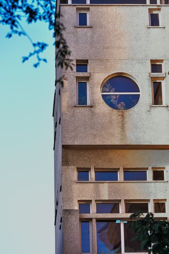 A vertical shot of the facade of a modern apartment building