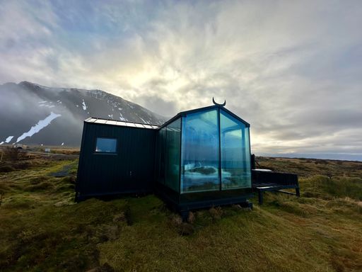 glass house in the mountains of iceland