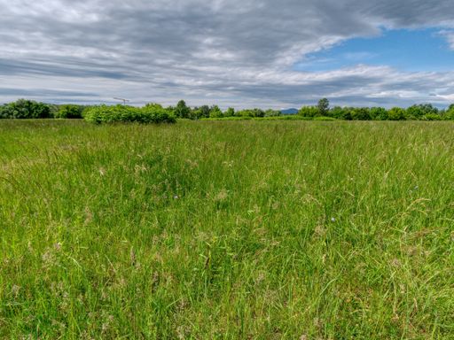 A beautiful landscape of an agricultural field under the cloudy sky