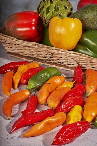 A vertical shot of fresh and dry colorful bellpeppers