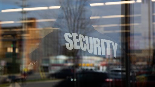 A closeup shot of  guard inside a commercial building with reflecting light of the window