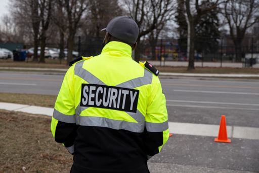 A rear view of a security guard watching over the parking area