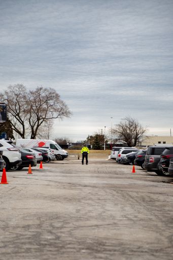 A vertical shot of a security guard watching over parking area