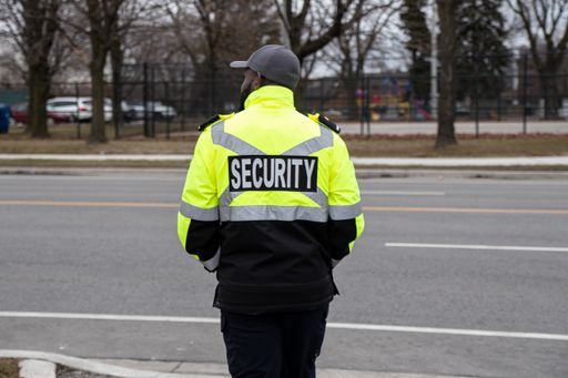 A closeup shot of a security guard watching the parking area