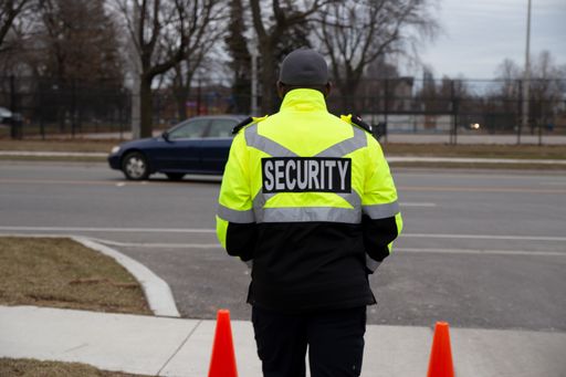 A closeup shot of a security guard watching over parking area