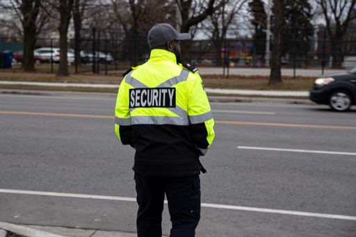 A closeup shot of a security guard watching over parking area