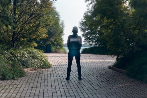 A closeup shot of a female security guard in uniform and watching over the park area