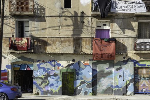 Photography of the old streets of Barcelona in the working class area, there is dirt and graffiti