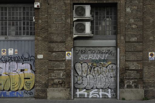 Photography of the old streets of Barcelona in the working class area, there is dirt and graffiti
