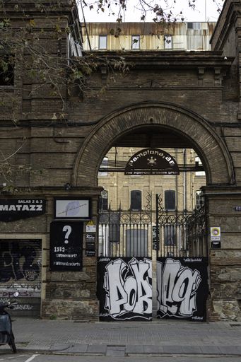 Photography of the old streets of Barcelona in the working class area, there is dirt and graffiti