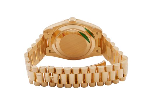 A closeup shot of a modern golden wristwatch on a white background