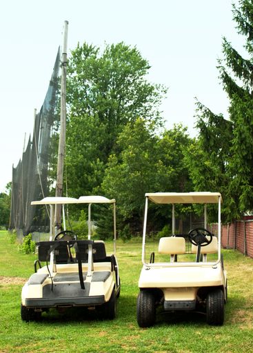 Two golf carts parked on a golf cours
