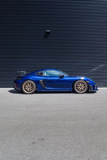 A beautiful brand new Gentian Blue Porsche Cayman GT4 RS waiting to be collected by the new owner and driven to the mountains.