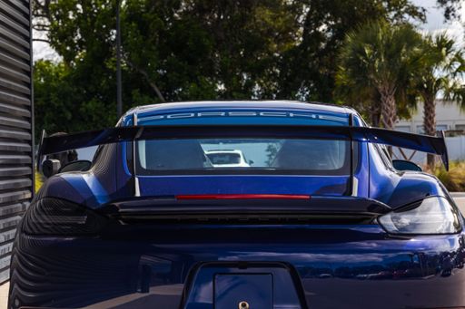 A beautiful new Gentian Blue Porsche Cayman GT4 RS awaiting collection by the new owner to be driven to the mountains.