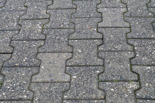 A high angle closeup shot of the grey cobblestone ground with patterns