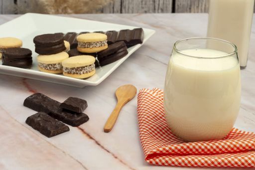 A closeup shot of freshly baked cookies and milk on a wooden table