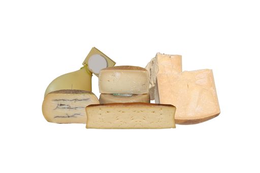 An array of assorted cheeses are arranged on a wooden table with slices of the various cheeses visible