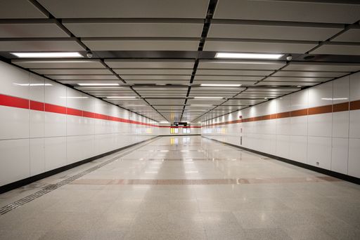 An empty subway tunnel with closed doors and multiple lanes, creating dramatic lighting.