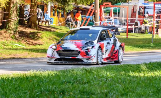 Toyota Yaris racing on tarmac rally stage at WRC championship in Croatia.