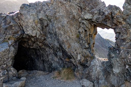 A mountain cave nestled on the side of the majestic peak
