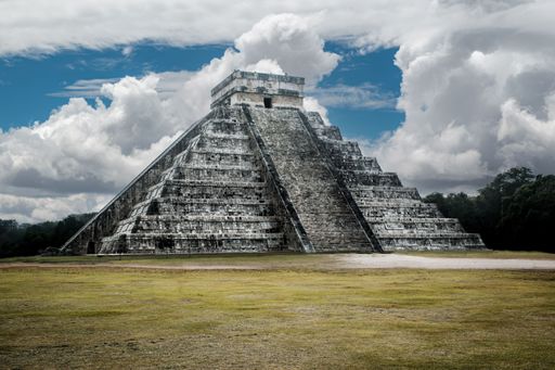 A scenic view of Chichen Itza Pyramid in Mexico under a beautiful cloudy sky