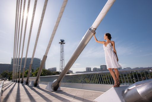 A Caucasian lady in an elegant dress on Seri Wawasan Bridge in Putrajaya, Malaysia