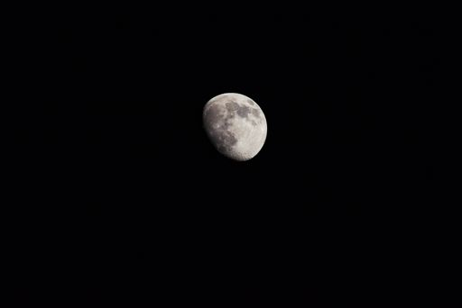 A closeup shot of the phase of the moon on a dark night